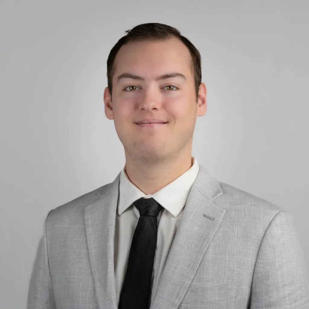 Man in gray suit and black tie