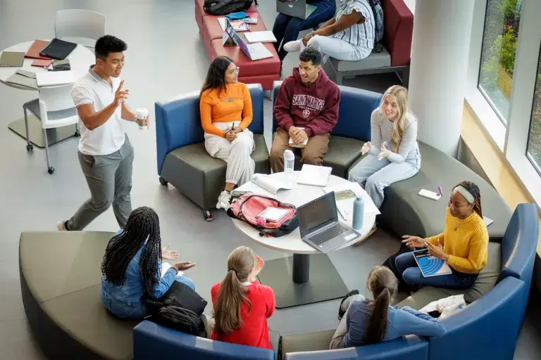 Students discussing in a casual lounge area.