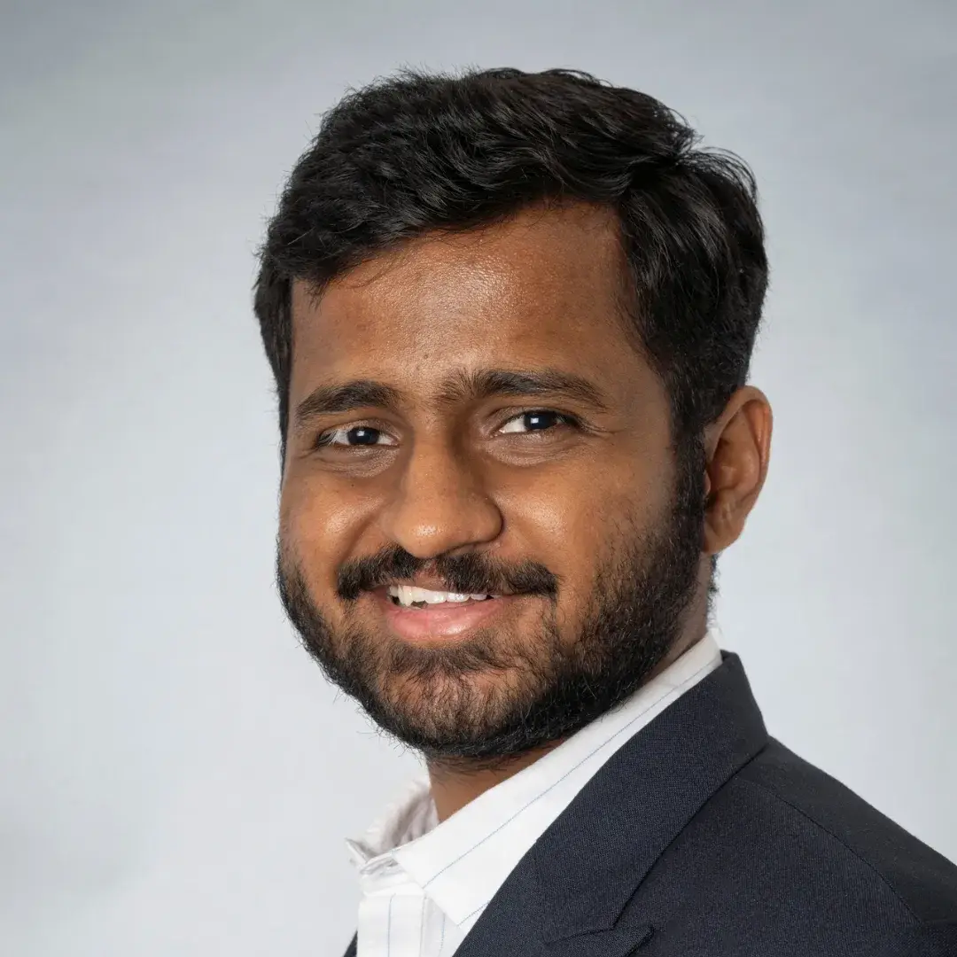 Smiling man in formal attire portrait photograph.