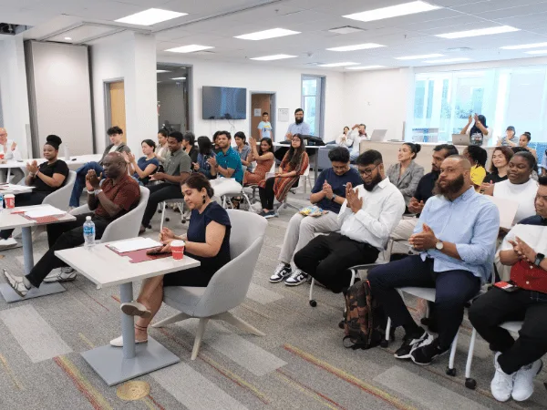 Diverse group attending educational seminar in conference room.