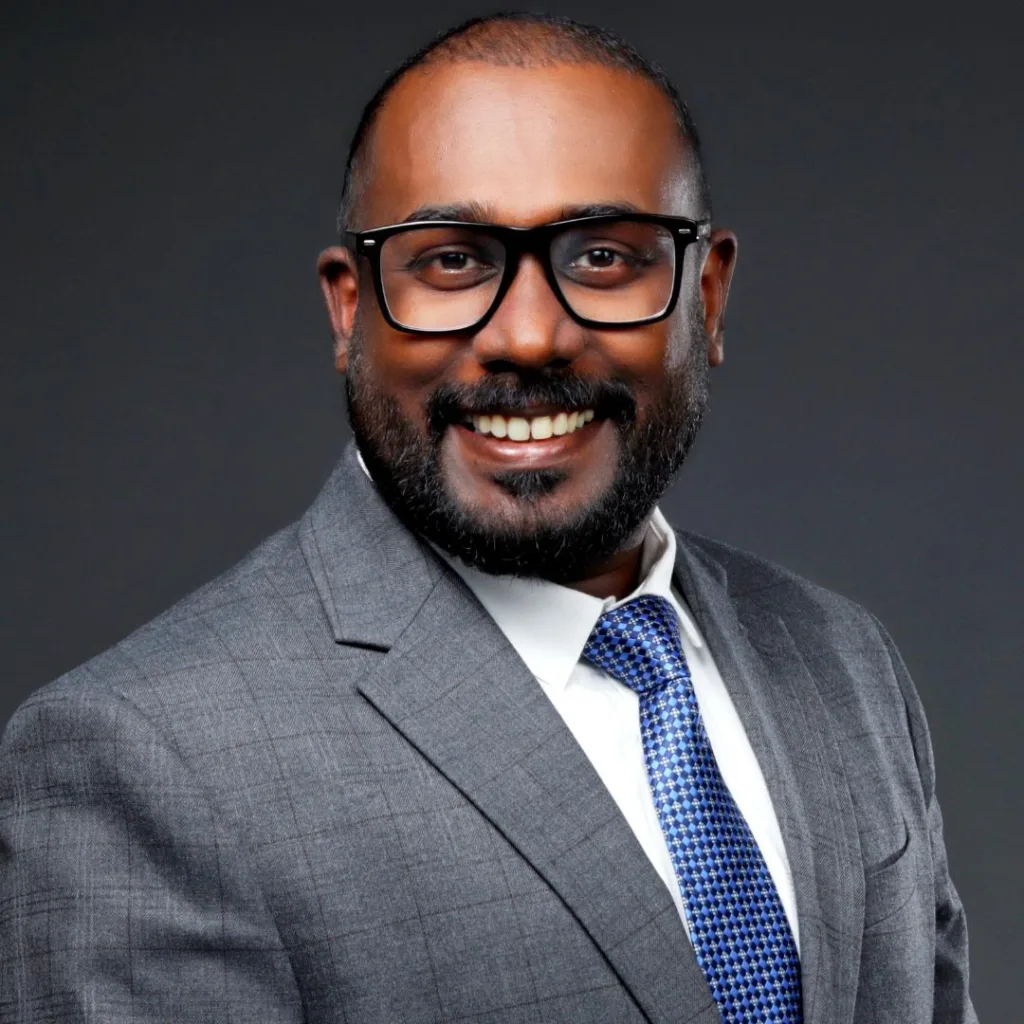 Smiling man in gray suit and glasses