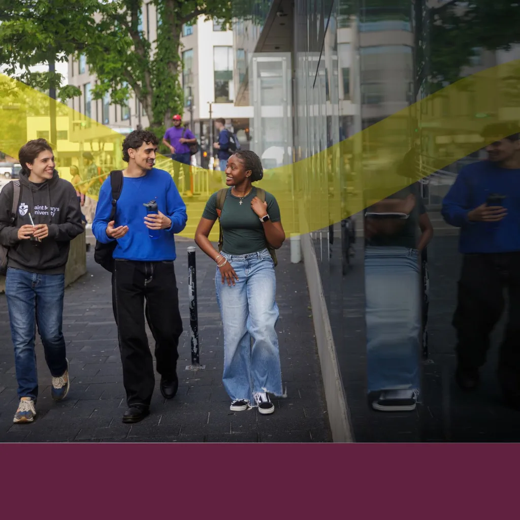Students walking and talking on campus pathway.