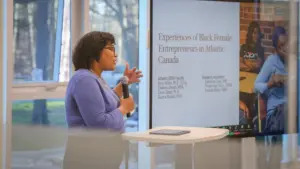 Woman presenting on Black female entrepreneurs in Canada.