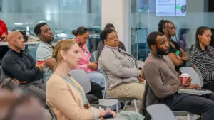 Audience attentively listens during conference session.