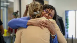 Two people sharing a warm embrace and smile.