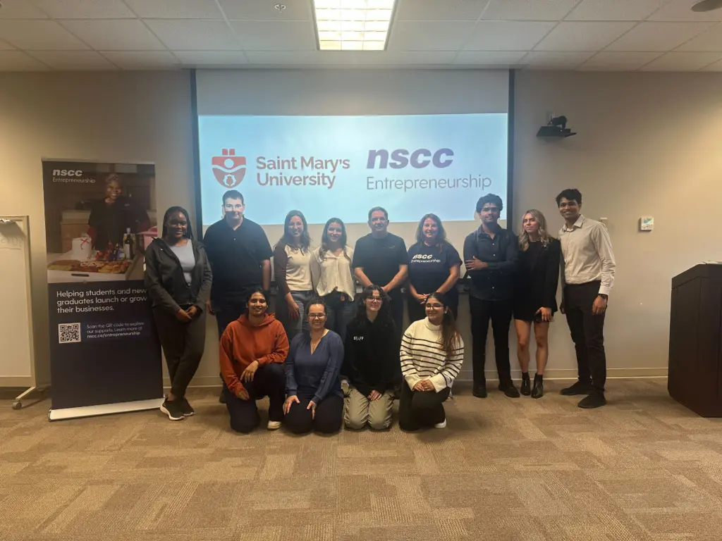 Group of diverse students in front of presentation slide.
