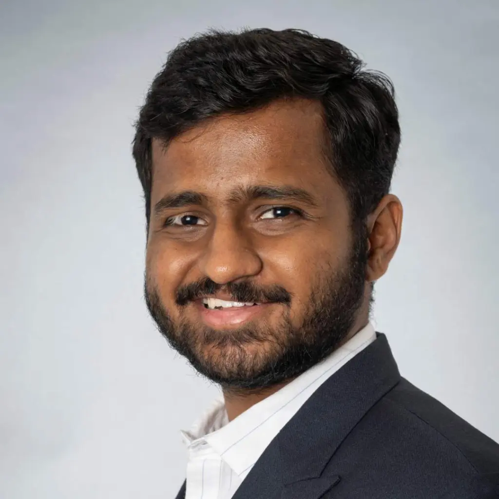 Smiling man in a suit, professional portrait.