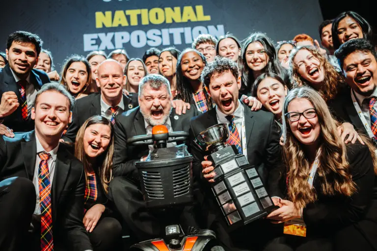 Group celebrating with trophy at national exposition.