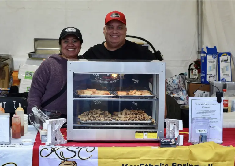 Smiling vendors at spring roll food stall