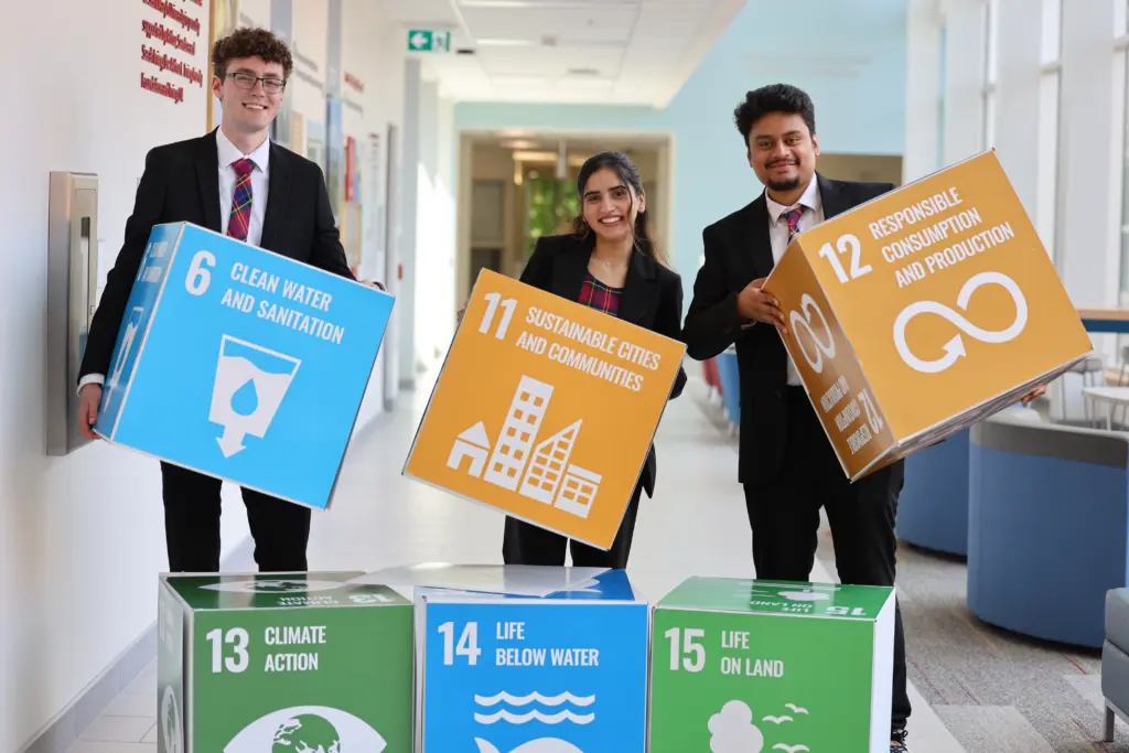 People holding UN sustainable development goals blocks.