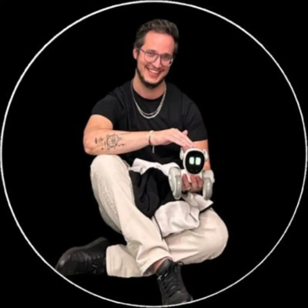 Person holding a small robot, smiling