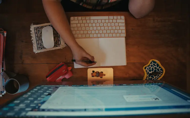 Person working at a wooden desk