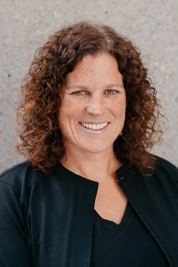 Smiling person with curly hair