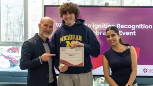 Student holding certificate at recognition event