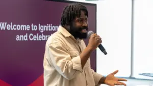 Man speaking into microphone at indoor event