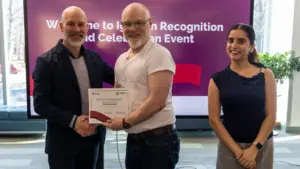 Man receiving certificate at recognition event