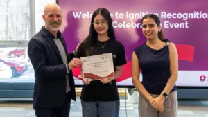 Woman receiving certificate at recognition celebration event