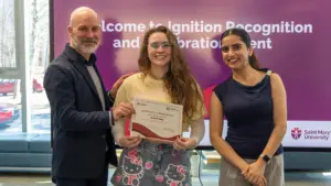Student receiving certificate at university recognition event