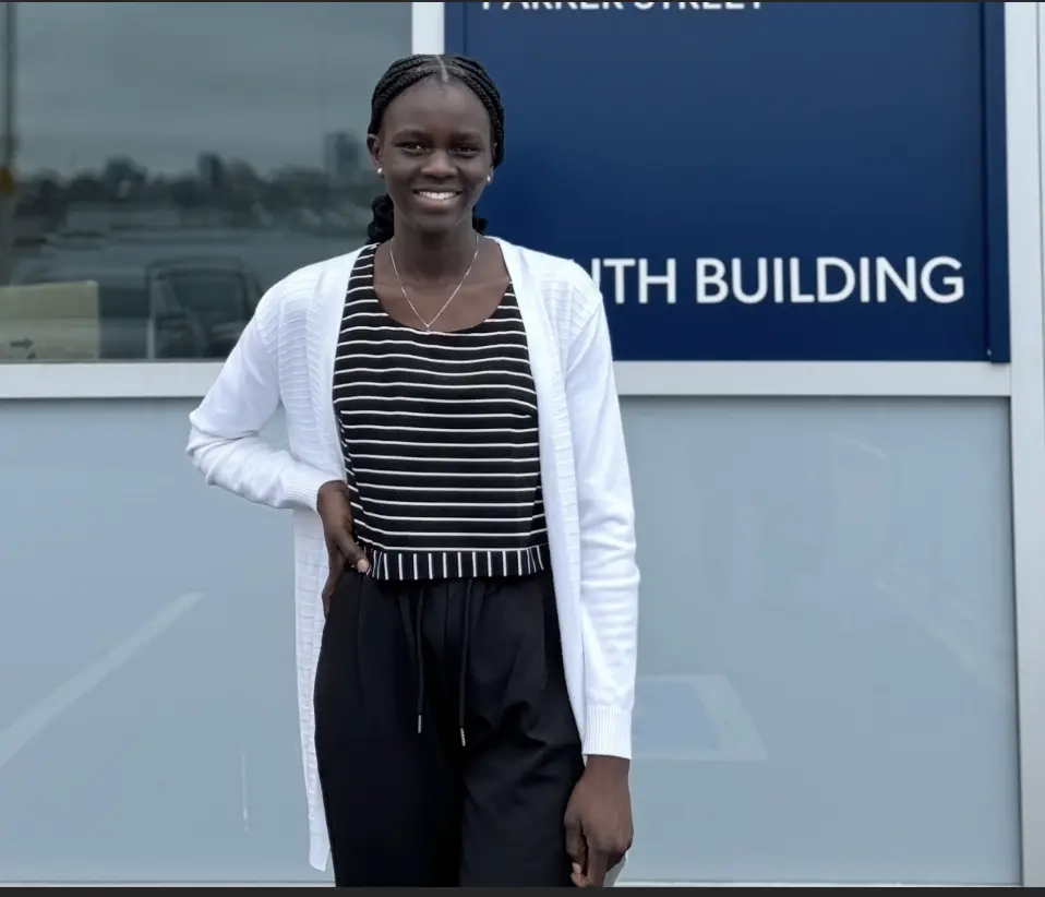 Woman smiling outside building entrance