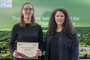 Two women holding certificate at award event