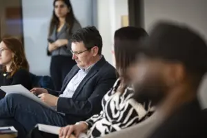 Business professionals reviewing documents in office meeting