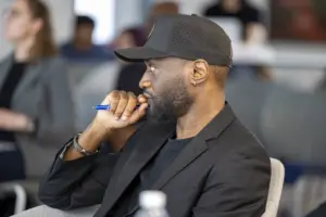 Man listening thoughtfully during meeting with pen