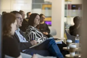 Professionals attending meeting in modern office space
