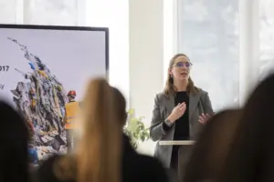 Woman presenting on waste management to audience