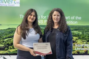 Two women holding certificate at university event