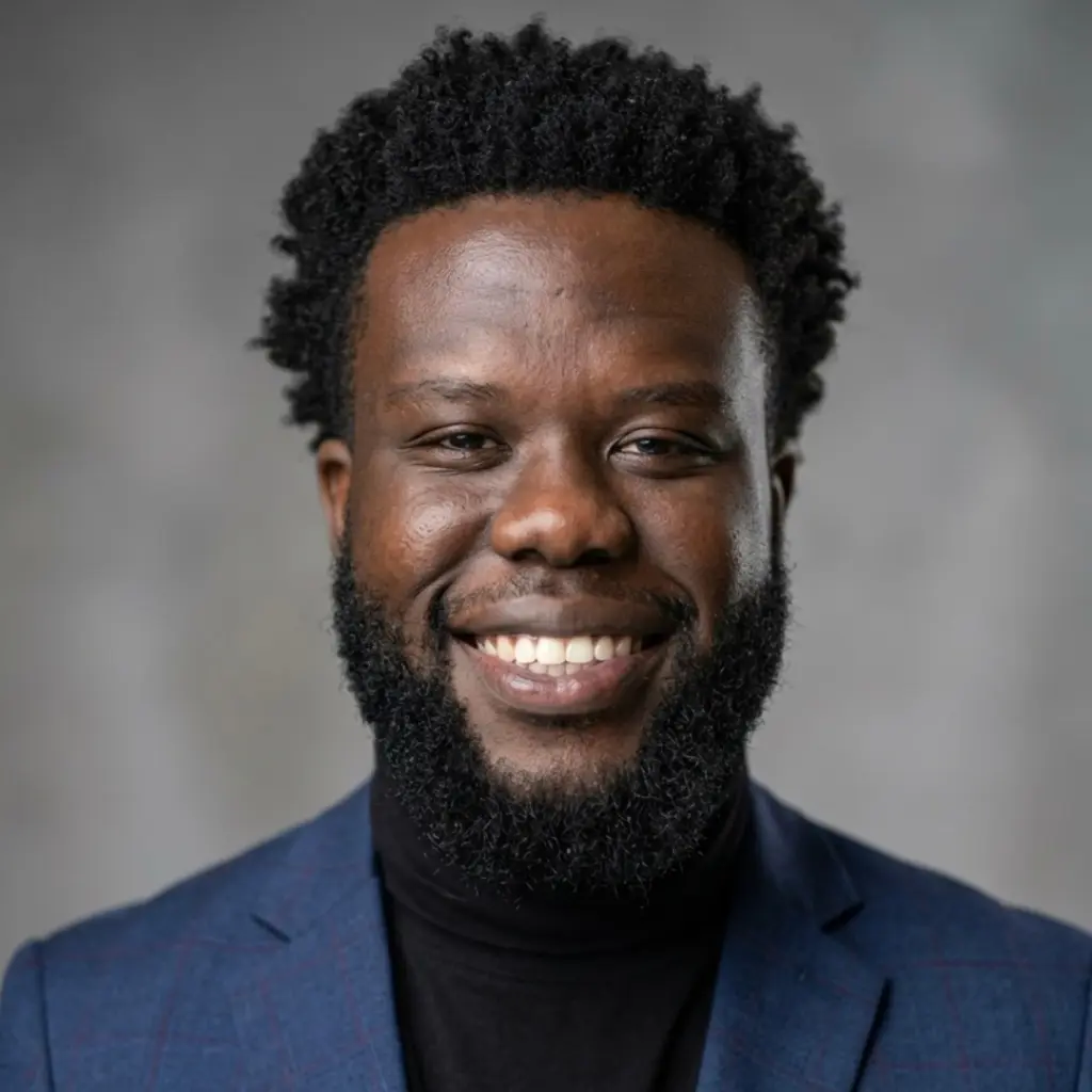 Smiling man in blazer with curly hair