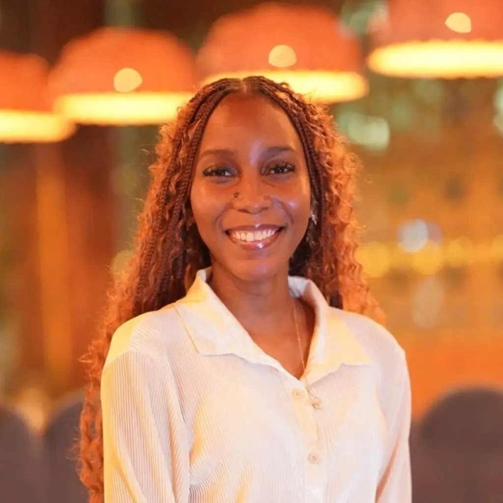 Smiling woman with braided hair in warm lighting