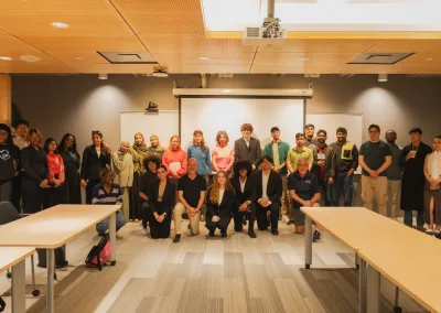 Large diverse group posing in classroom