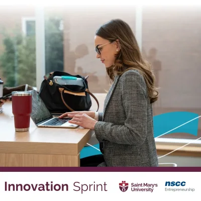 Woman working on laptop at Innovation Sprint event.