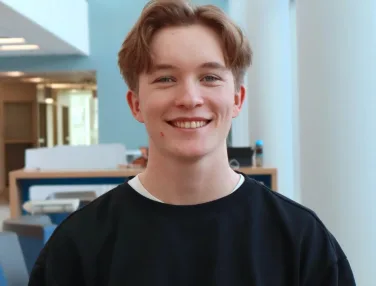 Smiling young man in modern office interior